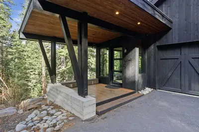 a barn with a wooden door and a garage at Sierra Sanctuary with Hot Tub home in Truckee