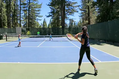 a group of people playing tennis on a tennis court at Double Suite Diamond Retreat in Incline Village