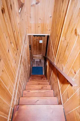 a staircase in a wooden cabin with a blue floor at Near Ski, Beaches, Pet Friendly, Full kitchen in South Lake Tahoe