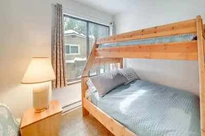 a bedroom with two bunk beds and a lamp at 1 Mi to Village and Eagle Lodge Condo with Fireplace in Mammoth Lakes