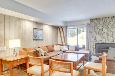 a living room with a couch and a table at 1 Mi to Village and Eagle Lodge Condo with Fireplace in Mammoth Lakes