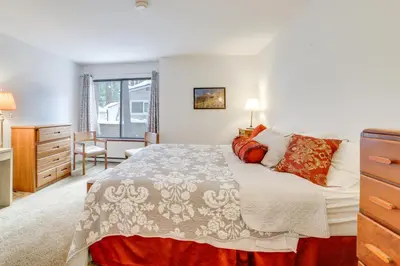 a bedroom with a bed and a desk and a window at 1 Mi to Village and Eagle Lodge Condo with Fireplace in Mammoth Lakes