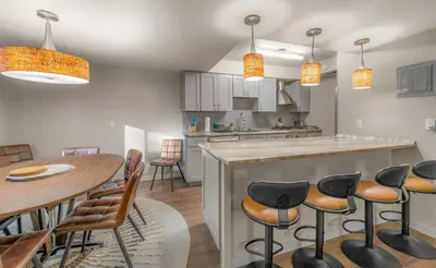 a kitchen with a bar and a table and chairs at Bavarian Village Escape For 6 in South Lake Tahoe