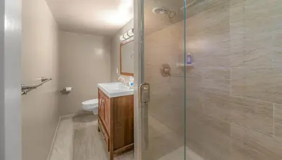 a bathroom with a glass shower with a toilet at Bavarian Village Escape For 6 in South Lake Tahoe