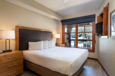 a bedroom with a large bed and a window at Top Floor Village Ski-In/Ski-Out Condo in Olympic Valley