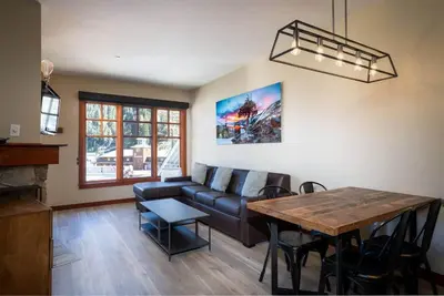 a living room with a couch and a table at Top Floor Village Ski-In/Ski-Out Condo in Olympic Valley