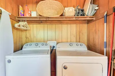 a kitchen with a stove and a washer and dryer at The Green Hideaway Arnold Cabin in the Pines! in Arnold