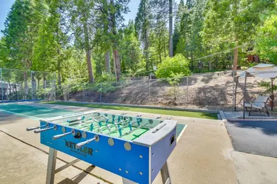a ping pong table on a tennis court at The Green Hideaway Arnold Cabin in the Pines! in Arnold