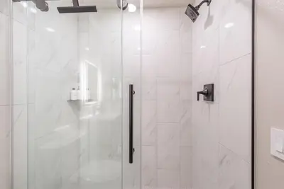 a shower with a glass door in a bathroom at Northstar Nest in Truckee
