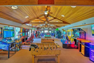 a room with several arcade games and tables at Northstar Nest in Truckee