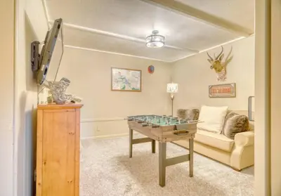 a living room with a table and a couch at StayCation Sierra – Nonpareil Retreat in Groveland