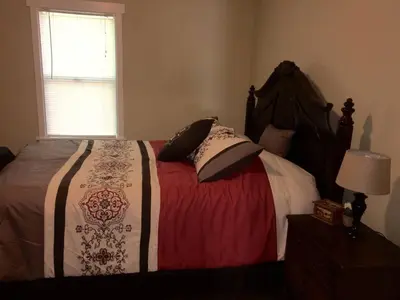 a bedroom with a large bed with pillows on it at Beautiful house by the river and the villager in Fair Oaks