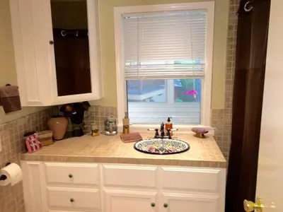 a kitchen counter with a sink and a window at Beautiful house by the river and the villager in Fair Oaks