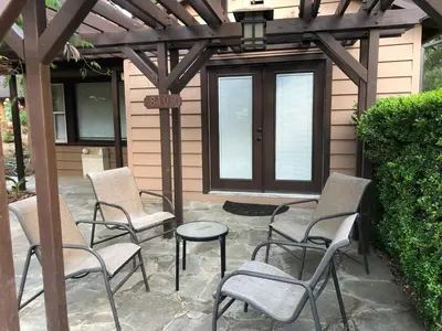a group of chairs and a table on a patio at The village Inn in Fair Oaks