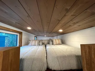 a bedroom with two beds in a small room at Cozy Modern Tiny Retreat with Yoga Dome, Garden, and Stargazing in Groveland, California in Groveland