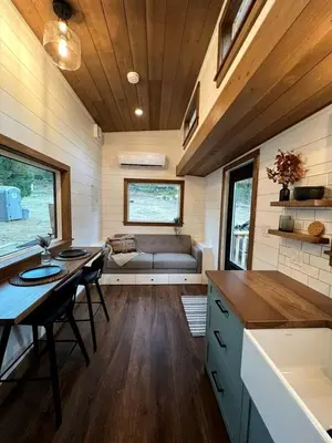 a kitchen and living room of a tiny house at Cozy Modern Tiny Retreat with Yoga Dome, Garden, and Stargazing in Groveland, California in Groveland