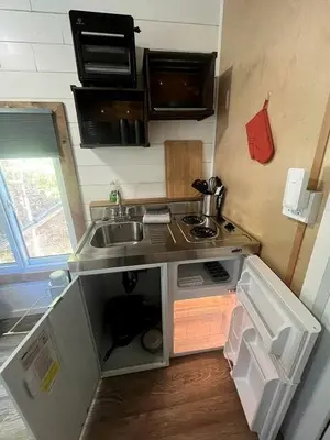a small kitchen with a sink and a stove at Cozy Modern Tiny Retreat with Stargazing & Yoga Dome Access Near Yosemite Tioga Pass, Groveland, California in Groveland