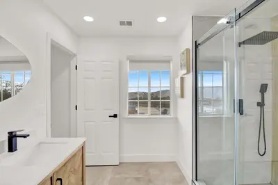 a white bathroom with a shower and a sink at Twilight Villa,Hot Tub,EV Charger,Yosemite and Bass lake in Oakhurst