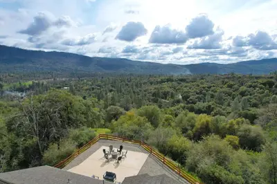 an overhead view of a patio with trees and mountains at Twilight Villa,Hot Tub,EV Charger,Yosemite and Bass lake in Oakhurst