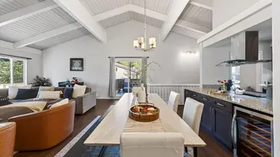 a kitchen and living room with a table and chairs at Pinecone Peak by AvantStay Incline Village Condo Fireplace Balconies Pool Access in Incline Village