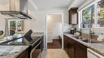 a kitchen with a sink and a counter top at Pinecone Peak by AvantStay Incline Village Condo Fireplace Balconies Pool Access in Incline Village