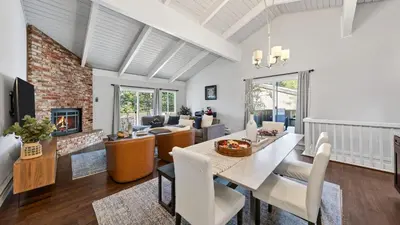 a living room with a dining table and a fireplace at Pinecone Peak by AvantStay Incline Village Condo Fireplace Balconies Pool Access in Incline Village