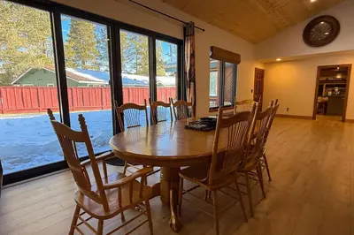 a dining room with a wooden table and chairs at Lazy Bear Manor in South Lake Tahoe