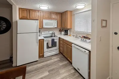 a kitchen with white appliances and wooden cabinets at Lakeview Gem in South Lake Tahoe