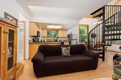 a living room with a couch and a kitchen at Mountain Paradise- Family Cabin w Pool Table in Shaver Lake