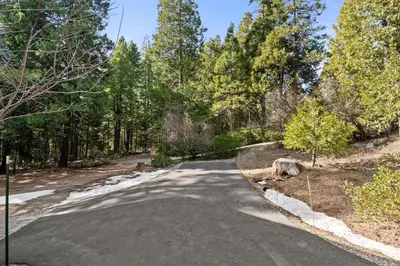 a road in the middle of a forest at Mountain Paradise- Family Cabin w Pool Table in Shaver Lake