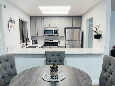 a kitchen with a table and two chairs and a counter at Cozy 2 bedroom 2 baths home in North Highlands