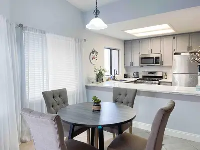 a kitchen with a table and chairs in a room at Cozy 2 bedroom 2 baths home in North Highlands