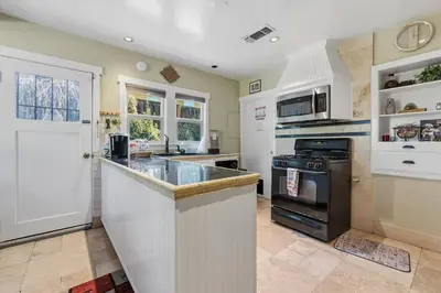 a kitchen with a counter and a stove at Beautiful house by the river and the villager in Fair Oaks