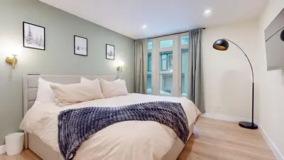a bedroom with a large bed and a large window at St, Moritz 34 Cozy Centrally Located Condo With Great Complex Amenities condo in Mammoth Lakes