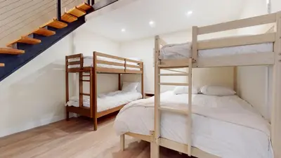 two bunk beds in a room with a staircase at St, Moritz 34 Cozy Centrally Located Condo With Great Complex Amenities condo in Mammoth Lakes