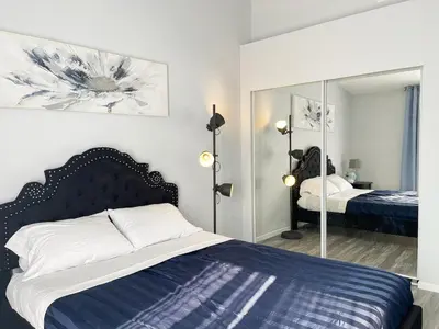 a bedroom with a bed and a mirror at Beautiful 2 bedroom 2 bathroom house in North Highlands