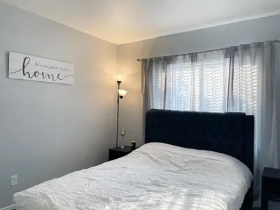 a bedroom with a bed and a window at Beautiful 2 bedroom 2 bathroom house in North Highlands