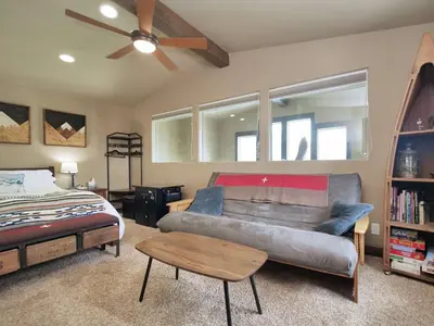 a living room with a couch and a bed at Kirkwood Mountainside Cabin Views Walk to Lifts in Kirkwood
