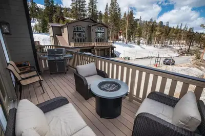 a deck with chairs and a grill on a house at Kirkwood Mountainside Cabin Views Walk to Lifts in Kirkwood