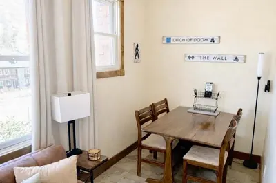 a living room with a wooden table and chairs at Kirkwood Mountainside Cottage Deck Walk to Lifts in Kirkwood