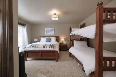 a bedroom with two bunk beds and a window at Kirkwood Mountainside Cabin & Cottage Deck wViews in Kirkwood