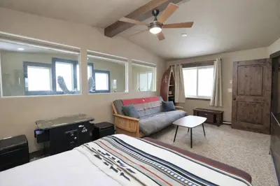 a bedroom with a bed and a couch at Kirkwood Mountainside Cabin & Cottage Deck wViews in Kirkwood