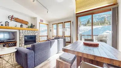 a living room with a table and chairs and a fireplace at Snowcreek V #777 condo in Mammoth Lakes
