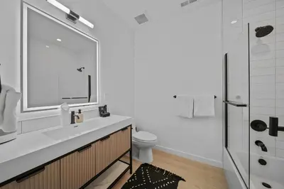 a white bathroom with a sink and a toilet at Donner Summit - Hot Tub, Fireplace & Mountain Views in Soda Springs