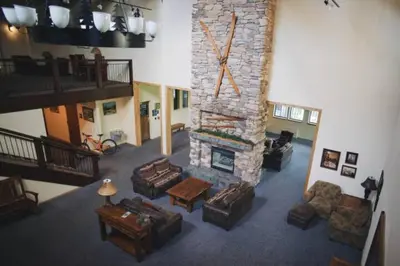 a living room with a stone fireplace with couches at The Meadows-Cozy Family Condo in Kirkwood Deck in Kirkwood