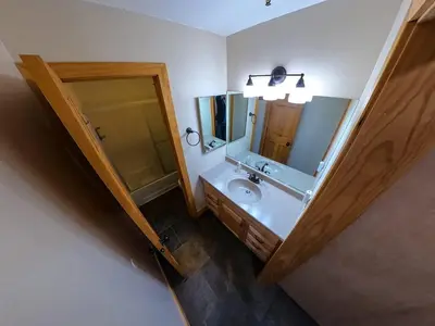 a bathroom with a sink and a mirror at The Meadows-Cozy Family Condo in Kirkwood Deck in Kirkwood