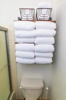 a stack of towels in a bathroom with a toilet at The Meadows-Cozy Family Condo in Kirkwood Deck in Kirkwood