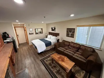 a living room with a bed and a couch at The Meadows-Cozy Hotel Room Deck in Kirkwood