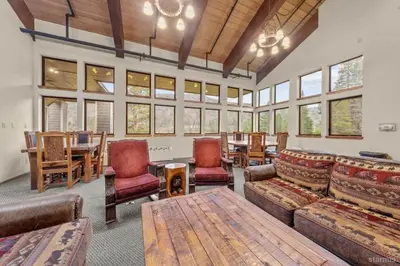 a living room with a couch and chairs and a table at The Meadows- Charmed Hotel Unit Steps to Ski Lifts in Kirkwood