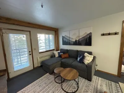 a living room with a couch and a table at The Meadows- Charmed Ski & Relax Studio in Kirkwood